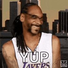 Snoop dogg is wearing a lakers jersey and smiling while wearing glasses 5454703152213046617