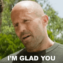 A bald man with a beard is smiling and says i m glad you8672382761814972399