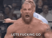 A man in a wrestling ring with his mouth open and the words lets  go above him999986657